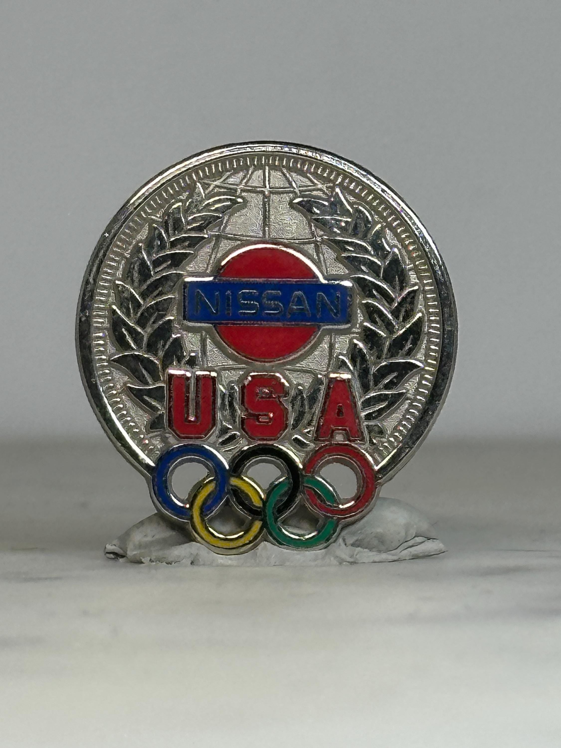 Nissan USA Olympic Pin: Silver Tone Enamel - Vintage Sports Accessory