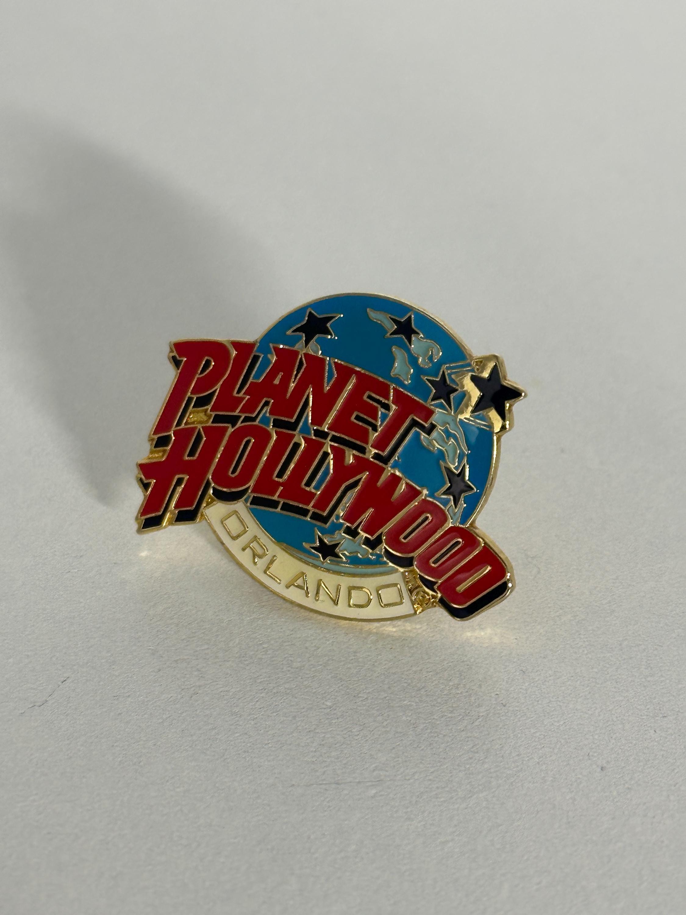 Planet Hollywood Enamel Pin: Red & Blue Globe Design - 1990s Collectible Accessory