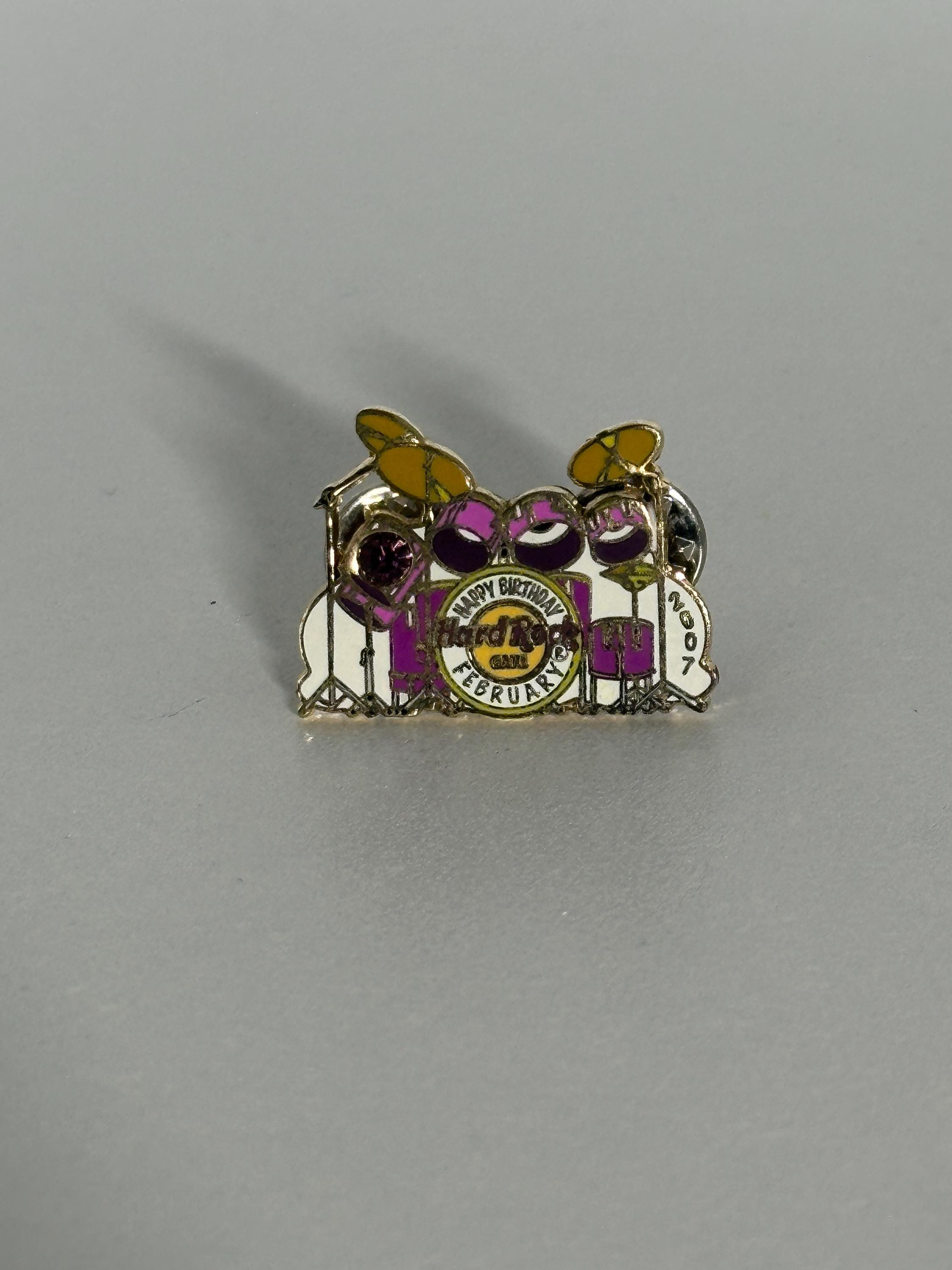 February Drum Set Enamel Pin With Decorative Birthday Stone: Purple & Yellow