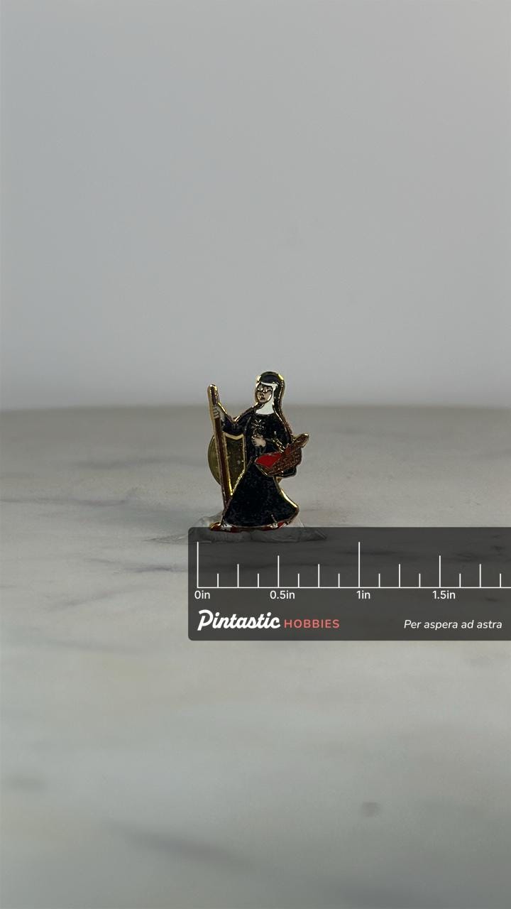 Saint Nun Enamel Pin: Black Cloak Gold Trim - Vintage Religious Accessory with ruler overlay for size reference