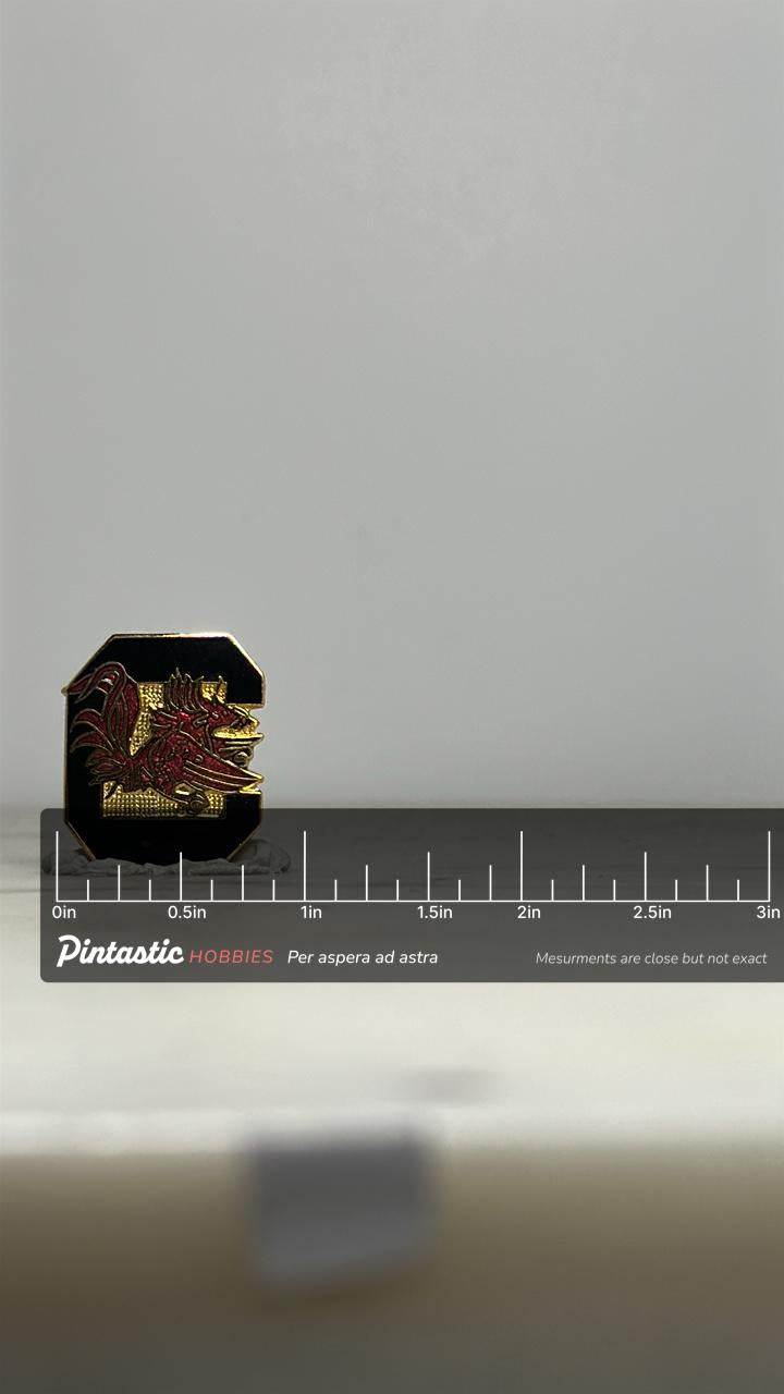 South Carolina Gamecocks Enamel Pin: Black & Gold Finish - Vintage Sports Accessory with ruler overlay for size reference