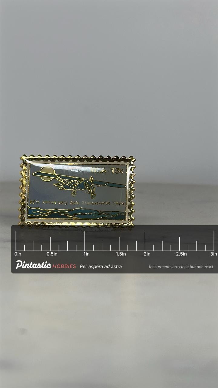Vintage Airplane Enamel Pin: Goldtone Stamp Shape - Aviation History Accessory with ruler overlay for size reference