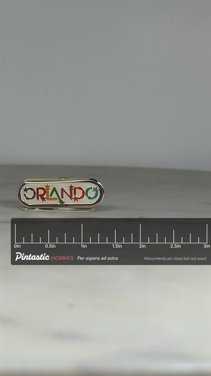 Orlando Souvenir Pin: Rainbow Enamel Gold Trim - Retro Travel Accessory with ruler overlay for size reference