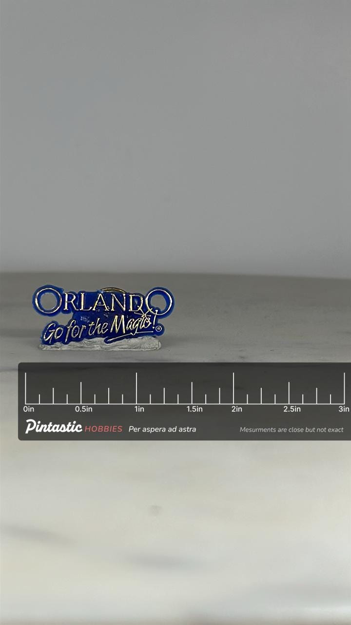 Orlando Souvenir Enamel Pin: Blue & Silver Text - Vintage Travel Accessory with ruler overlay for size reference