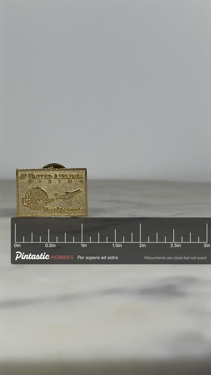 United Airlines Rising Pin: Gold Tone Rectangle - Aviation Collectible with ruler overlay for size reference