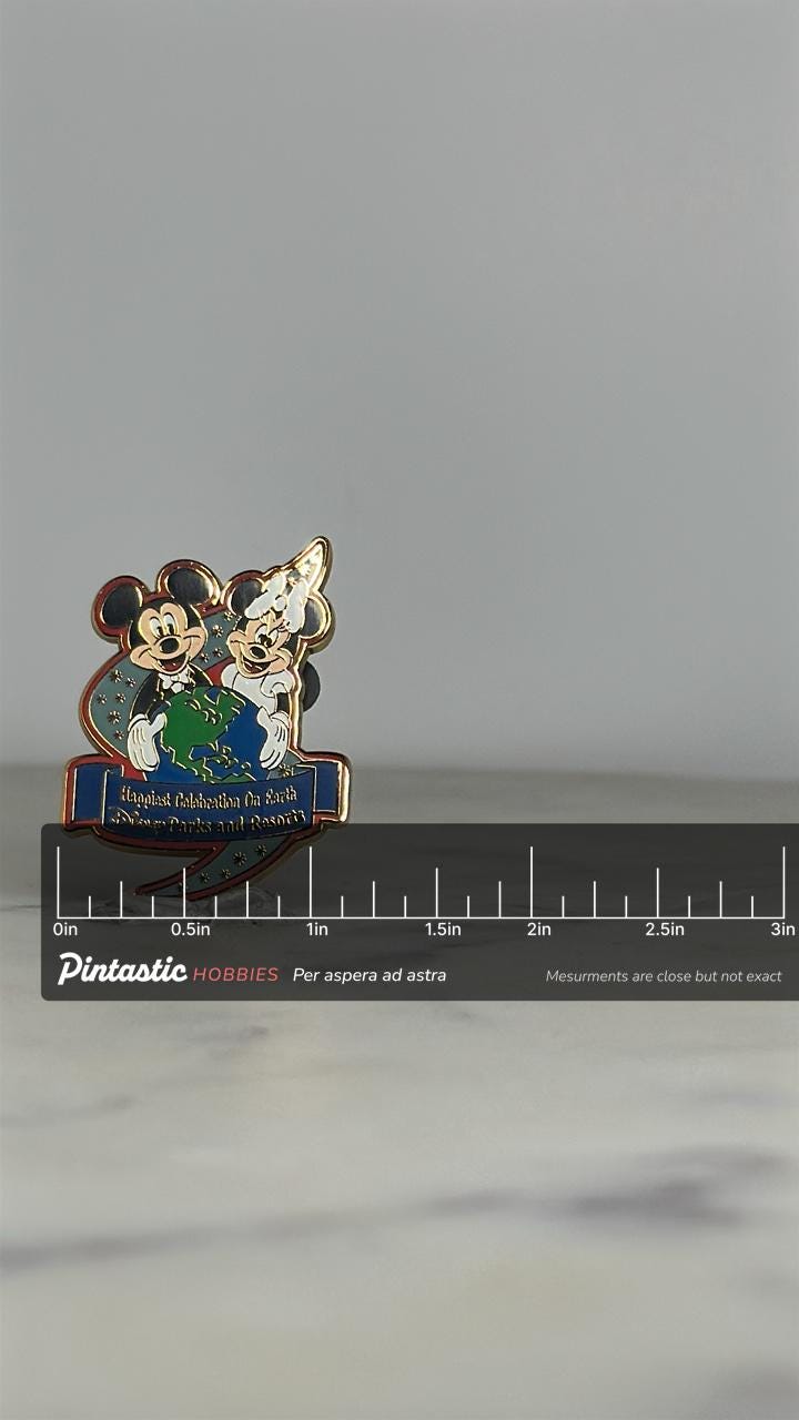 Mickey & Minnie Enamel Pin: Globe Design - Disney Parks Collectible with ruler overlay for size reference