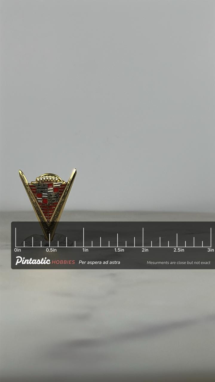 Cadillac Emblem Enamel Pin: Gold & Red Crest - Vintage Car Accessory with ruler overlay for size reference
