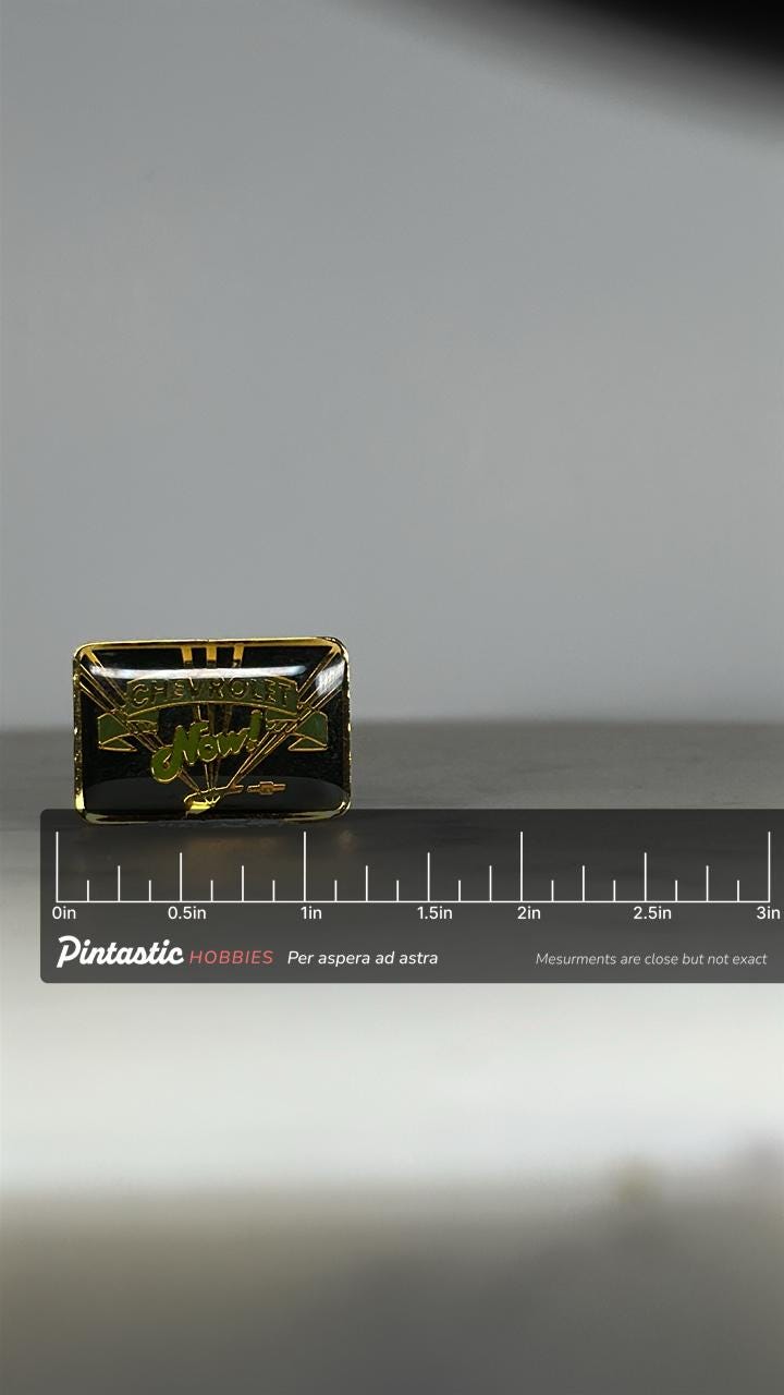 Chevrolet Logo Enamel Pin: Black & Gold - Vintage Auto Accessory with ruler overlay for size reference