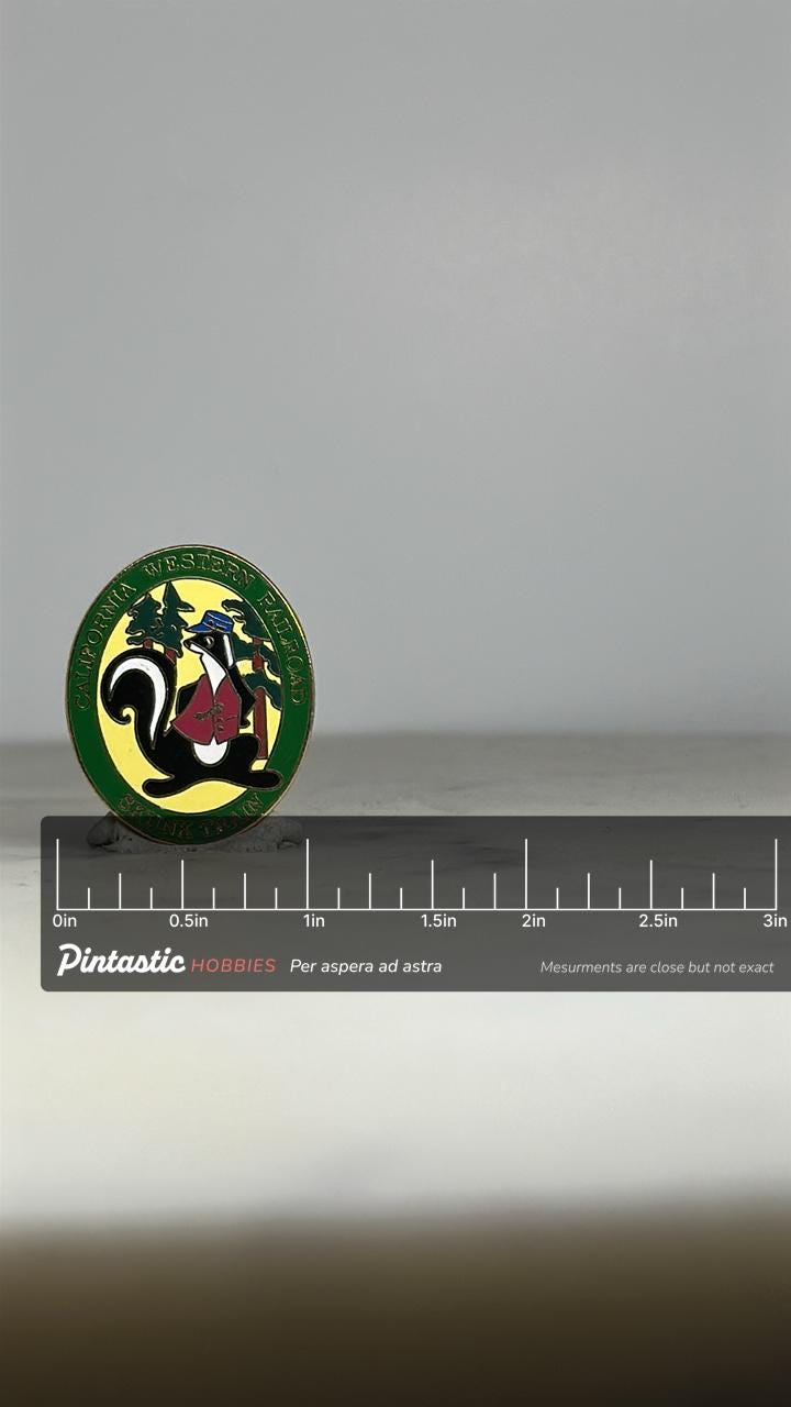 Skunk Train Railroad Enamel Pin: Green Gold Finish - Vintage Travel Accessory with ruler overlay for size reference