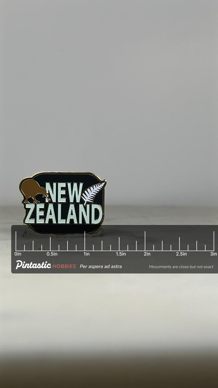 New Zealand Souvenir Pin: Black Enamel with Kiwi & Fern - Travel Accessory with ruler overlay for size reference