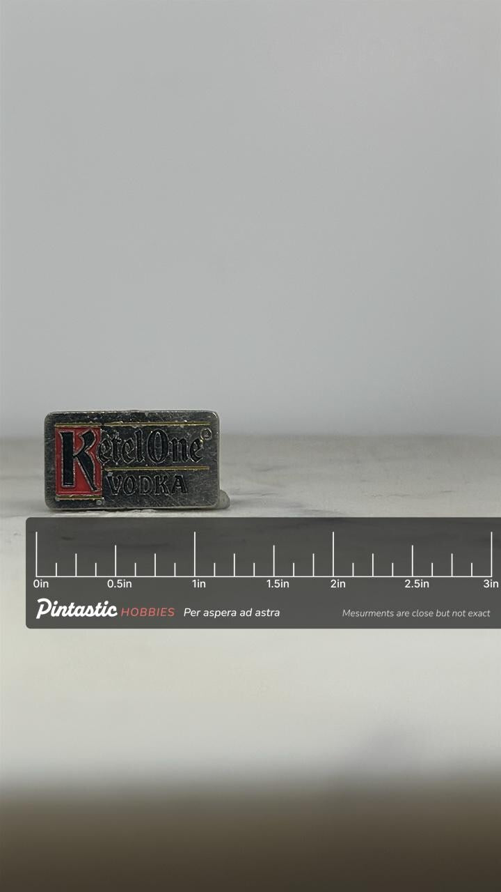 Ketel One Vodka Pin: Silver Enamel Logo - Vintage Barware Accessory with ruler overlay for size reference