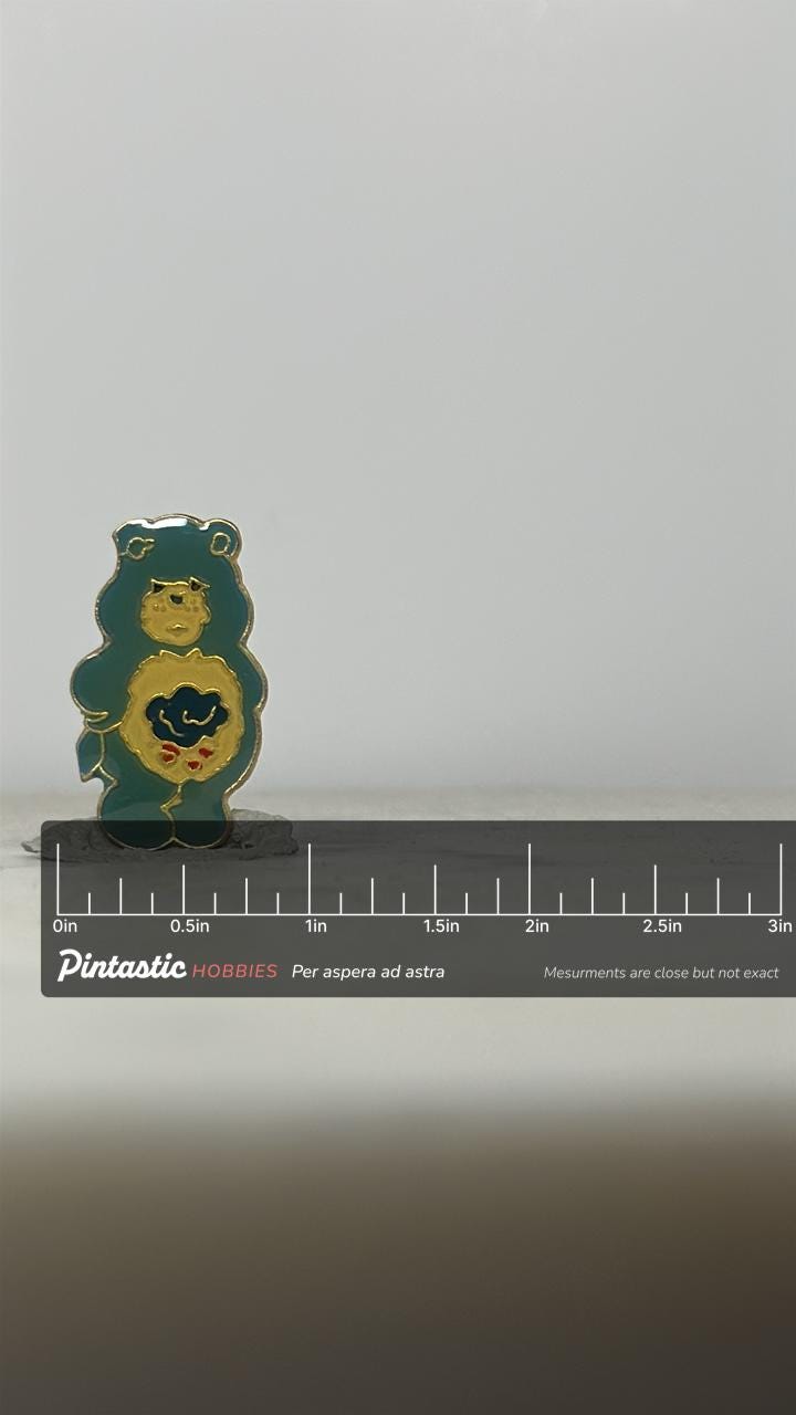 Care Bears Enamel Pin: Dark Green Cloud Belly - 1980s Cartoon Accessory with ruler overlay for size reference