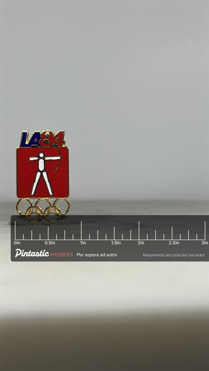LA84 Archery Olympic Pin: Red & Gold Enamel - 1984 Sports Accessory with ruler overlay for size reference