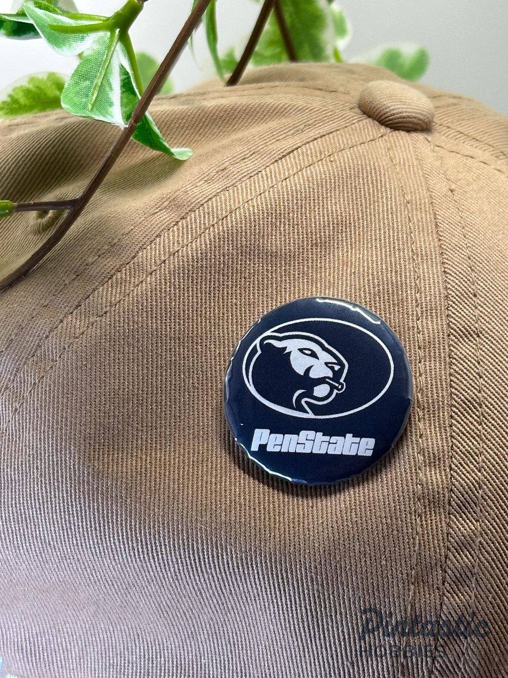 Penn State Inspired "PenState" 1.25 Inch Button Pin | University Style Parody Gift with ruler overlay for size reference