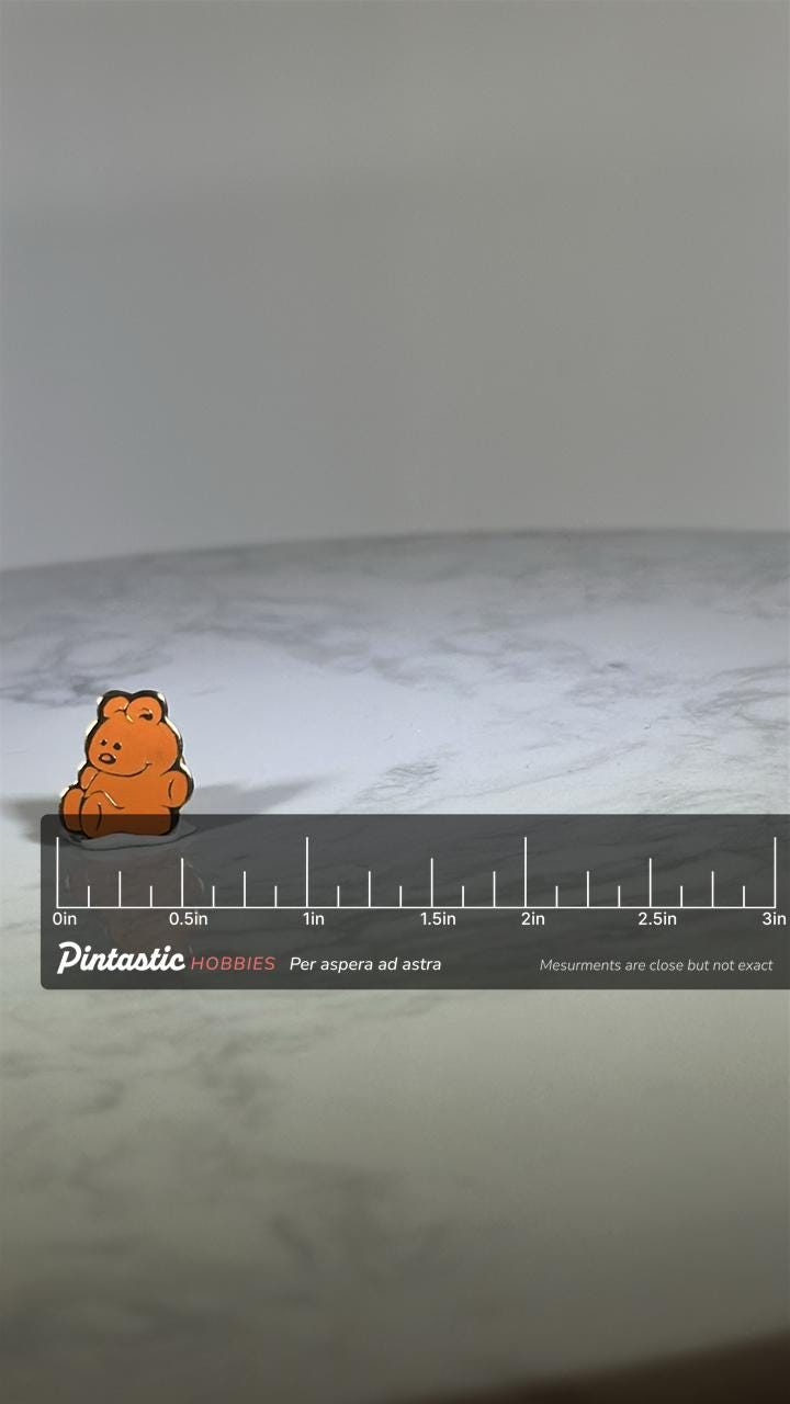 Orange Teddy Bear Pin: Glossy Enamel Finish - Retro Cute Accessory with ruler overlay for size reference