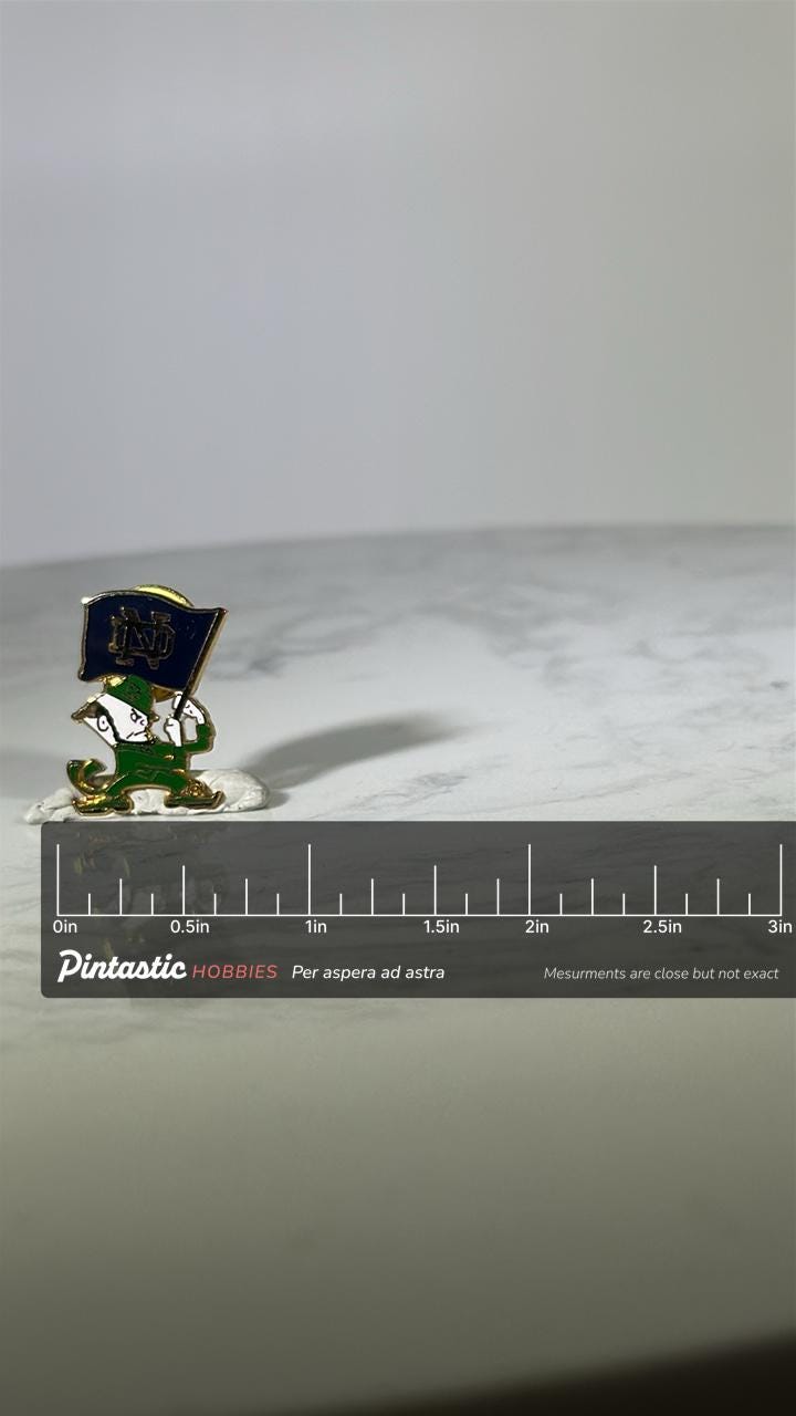 Notre Dame Leprechaun Pin: Gold Tone Enamel - Vintage College Accessory with ruler overlay for size reference