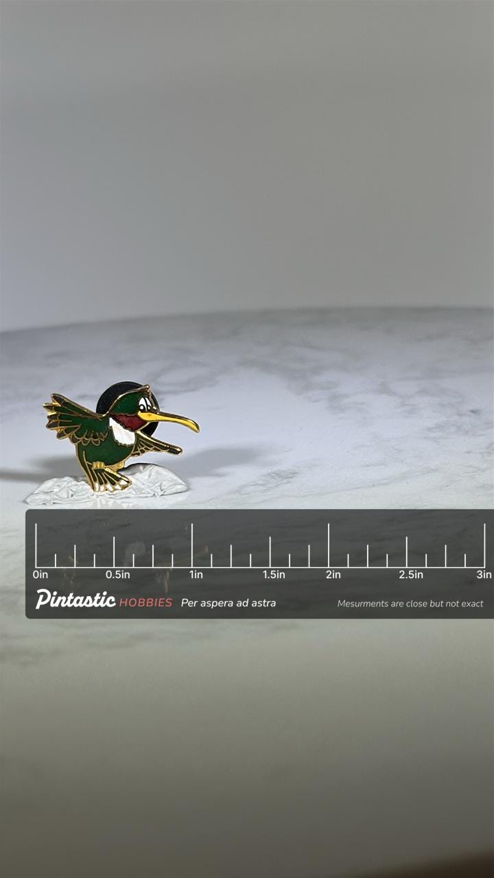 Cartoon Hummingbird Pin: Green Enamel Gold Trim - Whimsical 90s Accessory with ruler overlay for size reference