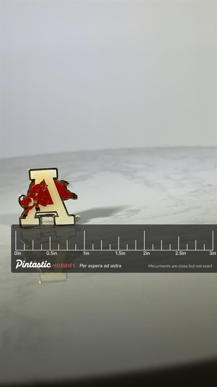 Arkansas Razorbacks Pin: Gold & Red Enamel - Vintage College Accessory with ruler overlay for size reference