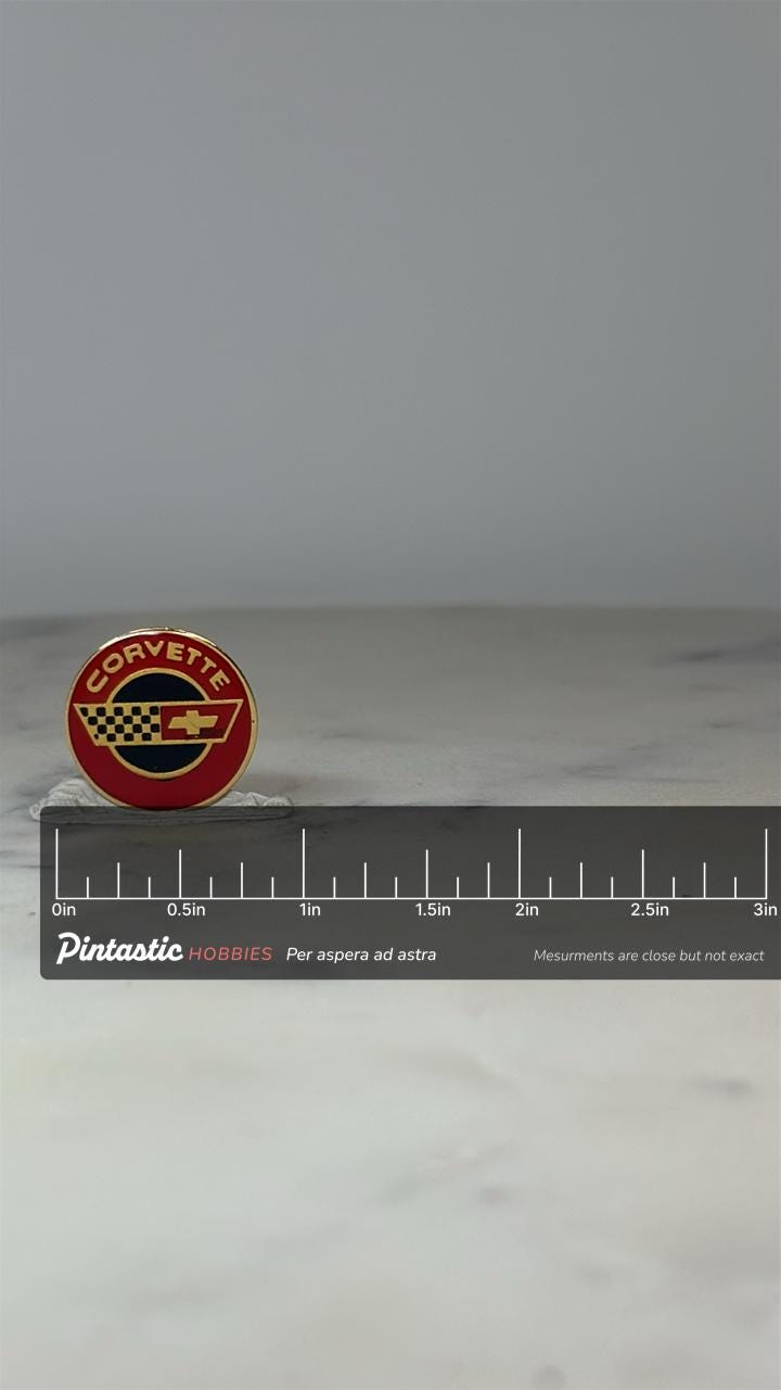 Corvette Emblem Pin: Red & Gold Enamel - Vintage Auto Accessory with ruler overlay for size reference
