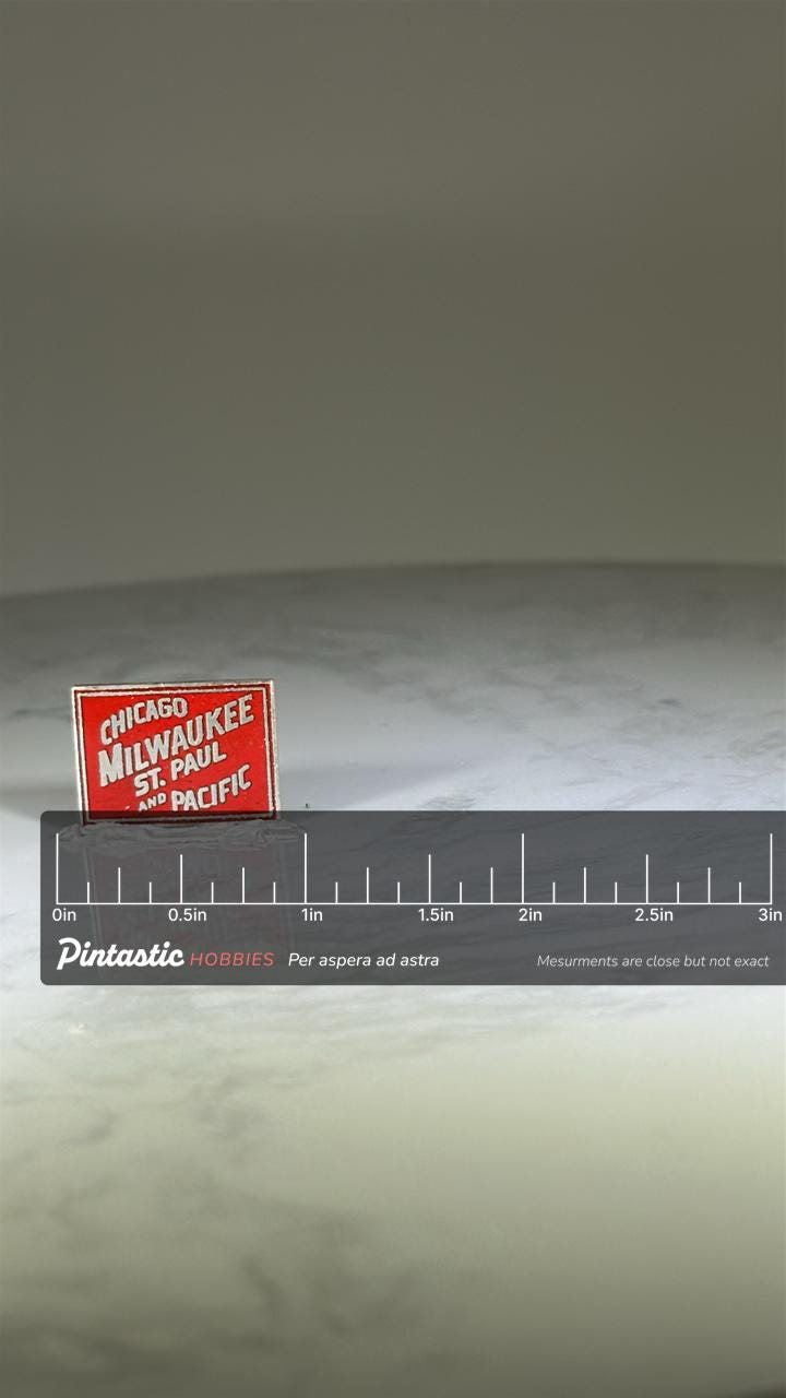 Chicago Milwaukee Railroad Pin: Red Enamel Finish - Vintage Train Accessory with ruler overlay for size reference