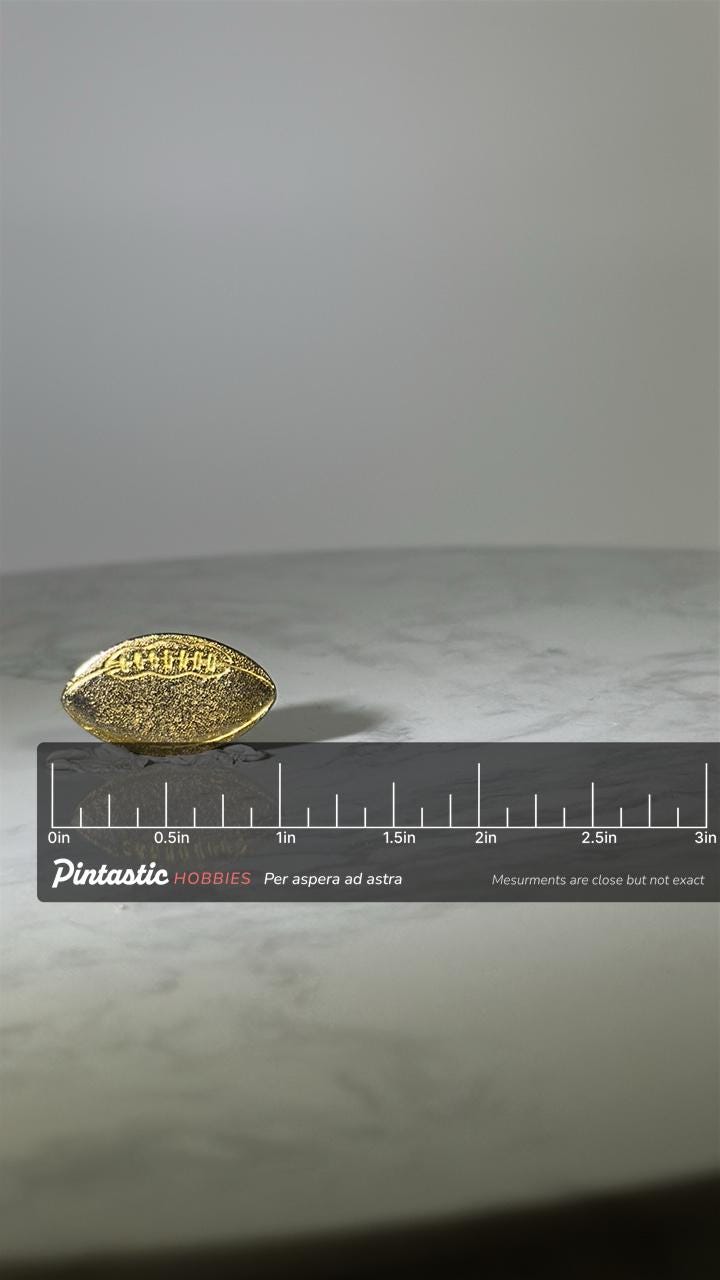 Football Shaped Pin: Textured Gold-Tone - Classic Sports Accessory with ruler overlay for size reference
