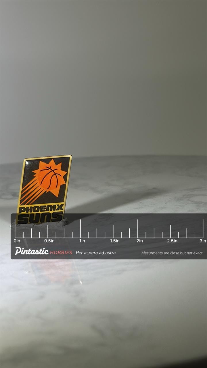 Phoenix Suns Enamel Pin: Black & Orange - Vintage Sports Accessory with ruler overlay for size reference