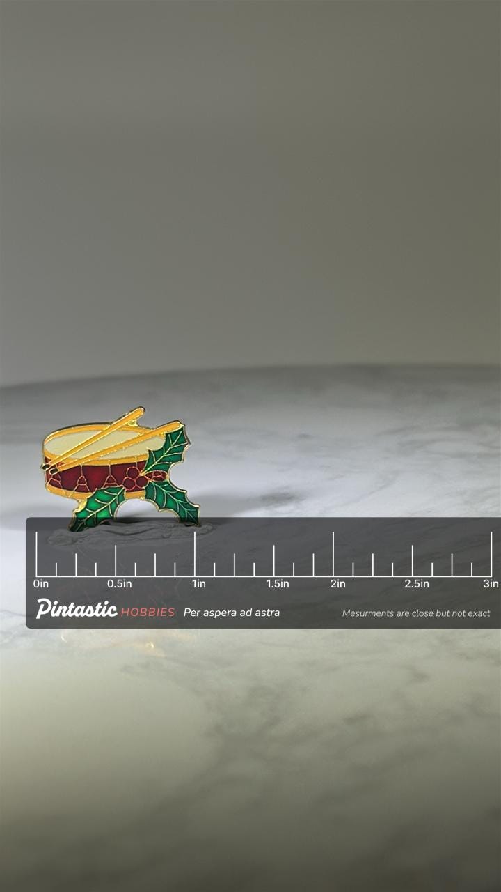 Christmas Drum Pin: Enamel Goldtone Finish - Holiday Accessory with ruler overlay for size reference