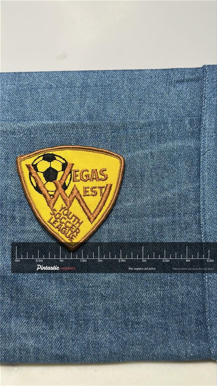 Vegas West Youth Soccer Patch: Sew-On Gold Shield - Vintage Sports Accessory with ruler overlay for size reference