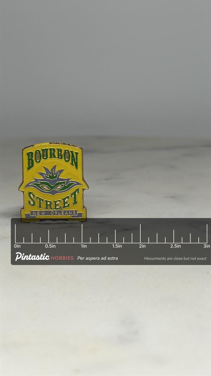 Bourbon Street Enamel Pin: Yellow Green Mask Design - New Orleans Souvenir with ruler overlay for size reference