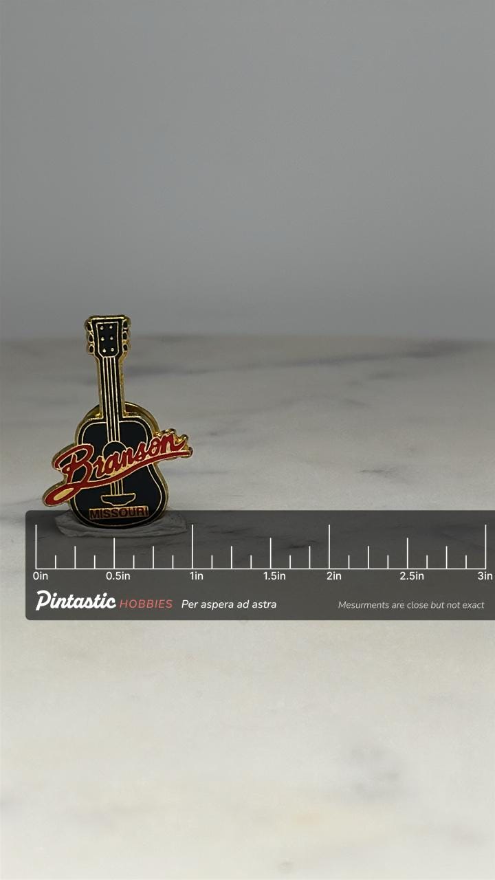 Branson Missouri Guitar Pin: Black Enamel Gold Trim - Travel Souvenir Accessory with ruler overlay for size reference