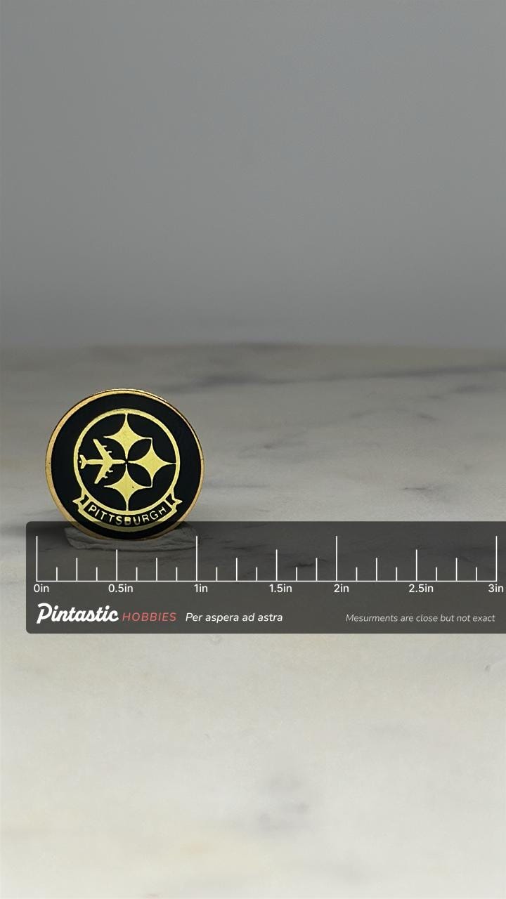 Pittsburgh Airport Souvenir Pin: Black & Gold Enamel - Retro Travel Accessory with ruler overlay for size reference
