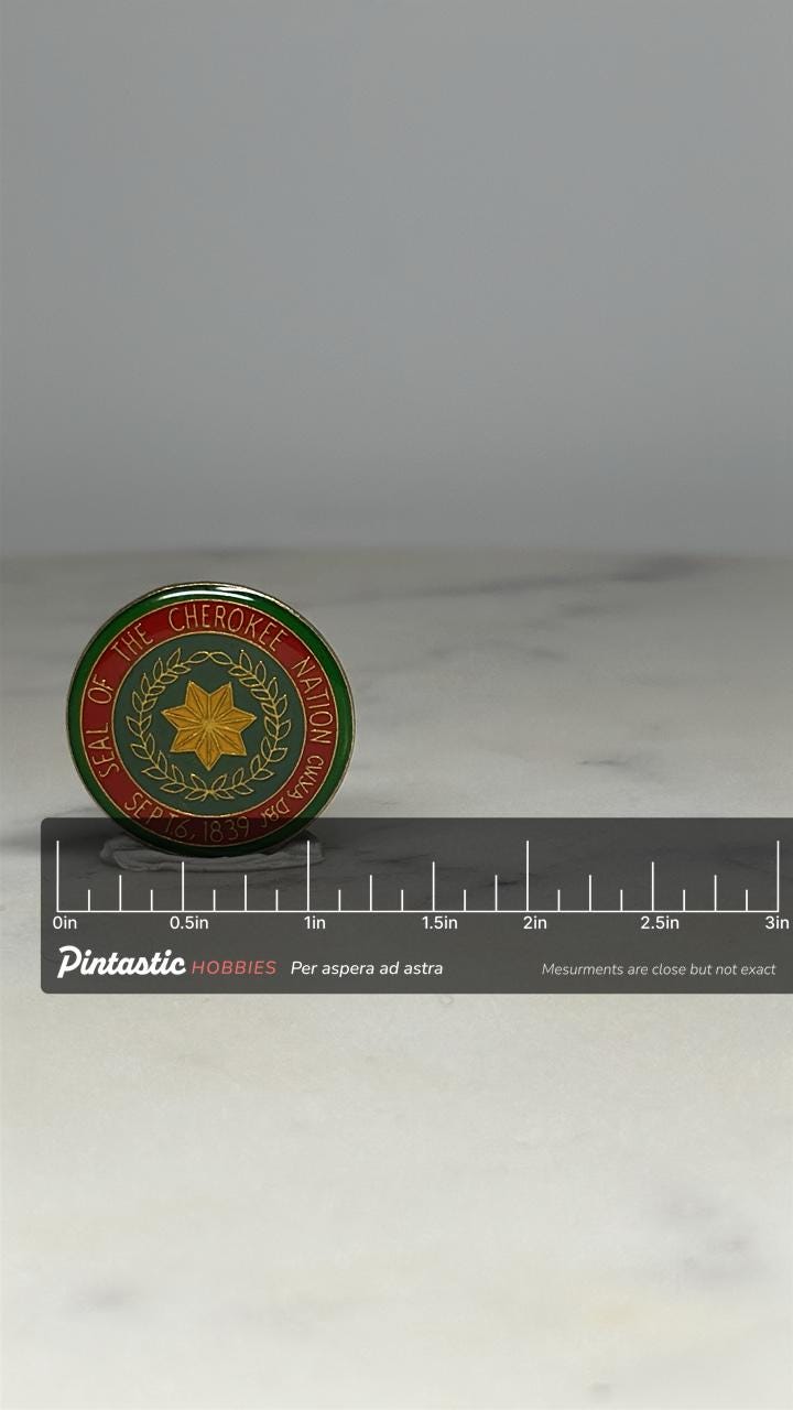 Cherokee Nation Seal Pin: Gold & Red Enamel - Heritage Collectible Accessory with ruler overlay for size reference