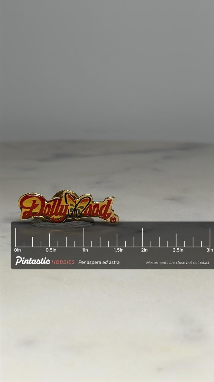 Dollywood Logo Pin: Red Enamel Gold Tone - Vintage Theme Park Accessory with ruler overlay for size reference