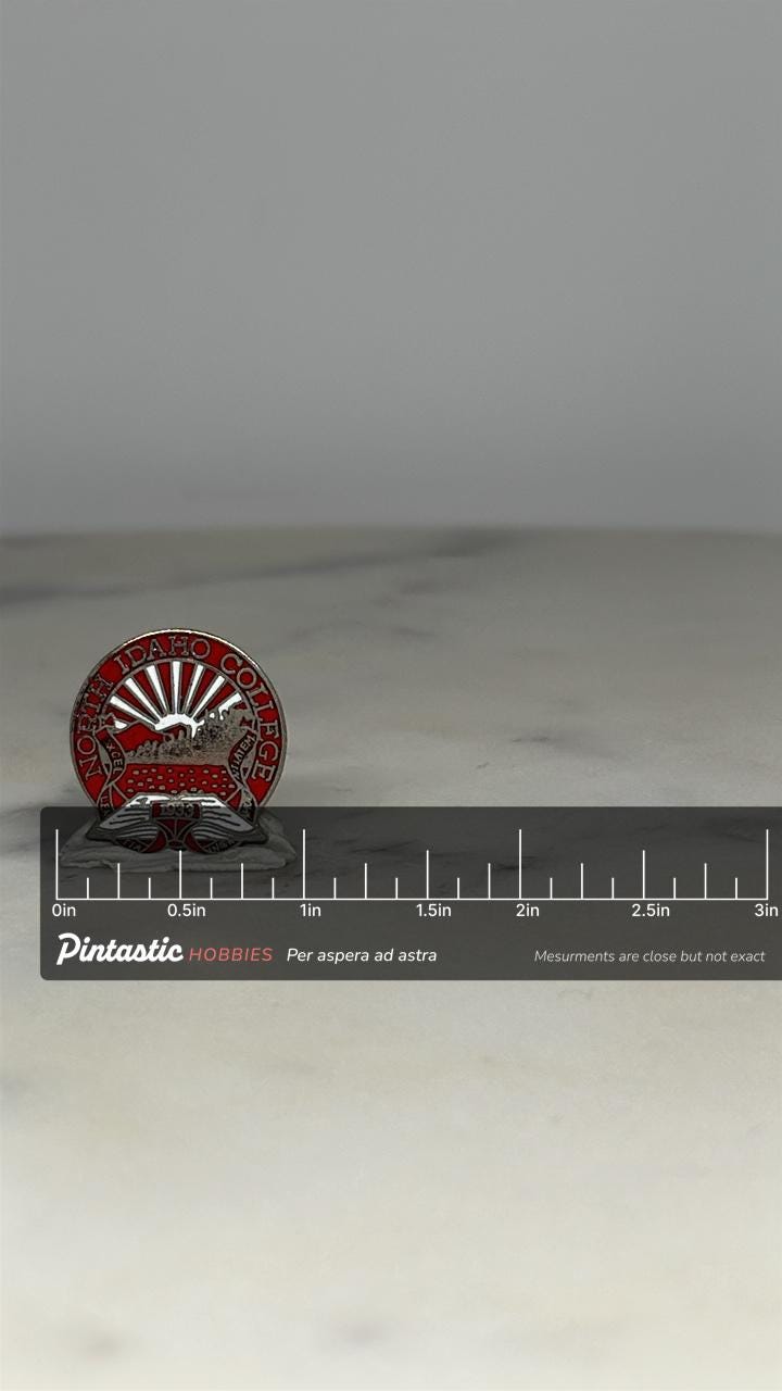 North Idaho College Pin: Red Enamel Pewter - 1983 Vintage Accessory with ruler overlay for size reference