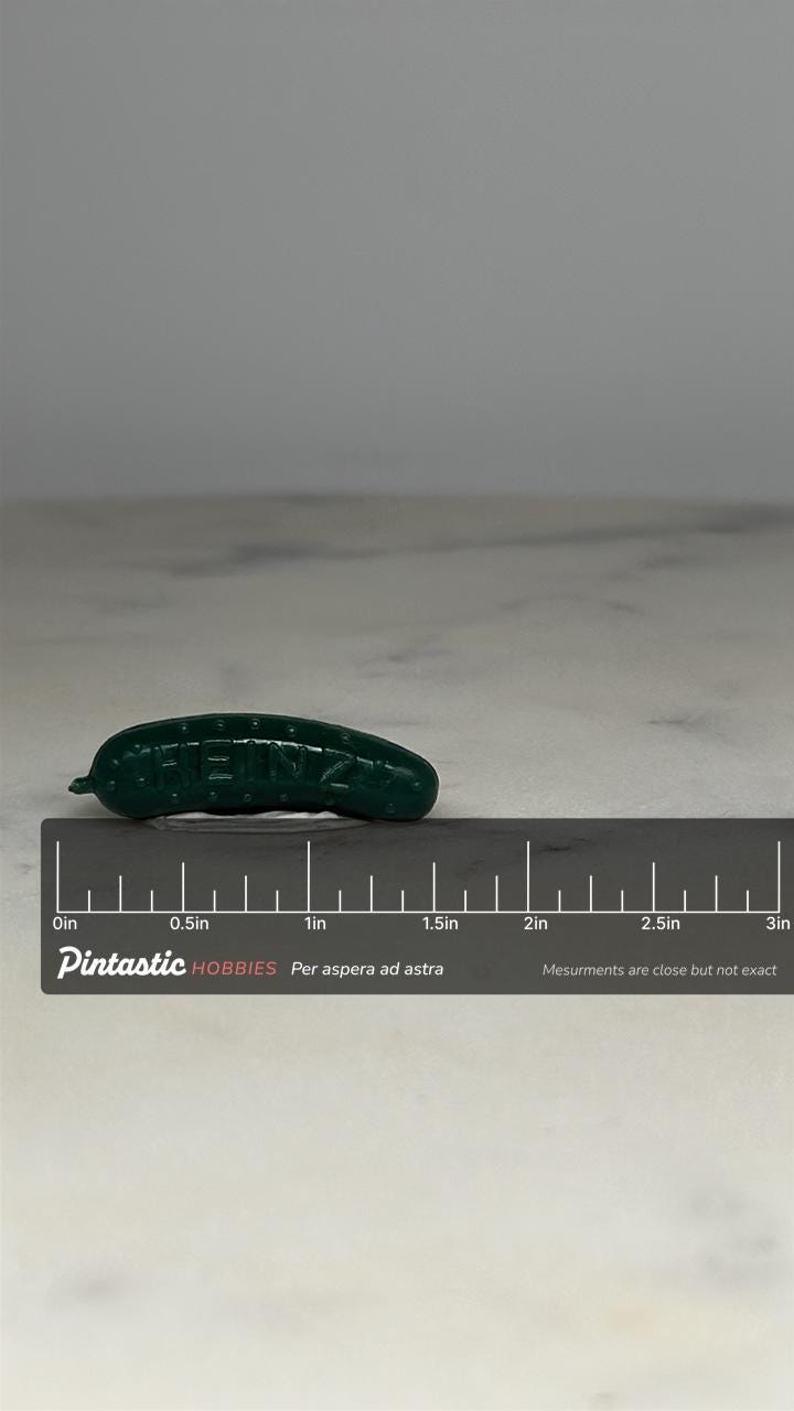 Heinz Pickle Promotional Pin: Green Plastic - Retro Advertising Accessory with ruler overlay for size reference
