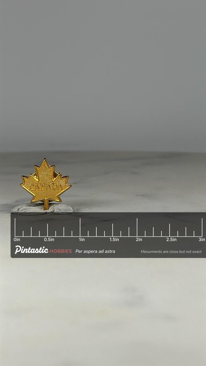 Canada Maple Leaf Pin: Gold Tone Finish - Patriotic Souvenir Accessory with ruler overlay for size reference