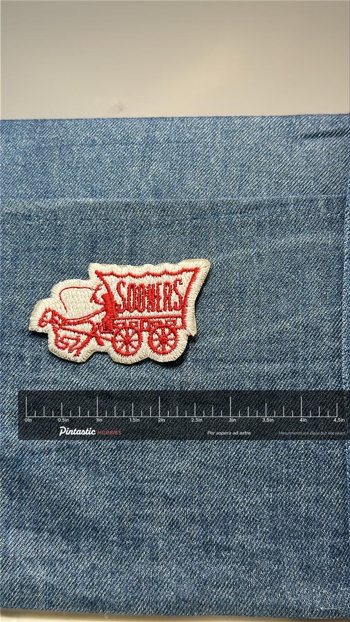Oklahoma Sooners Patch: Iron-On Red & White Wagon - Vintage Sports Accessory with ruler overlay for size reference