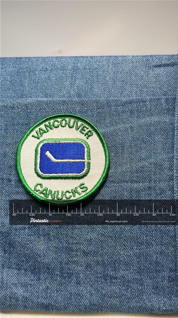 Vancouver Canucks Collectable Patch: Sew-On Green Border - Retro Sports Accessory with ruler overlay for size reference