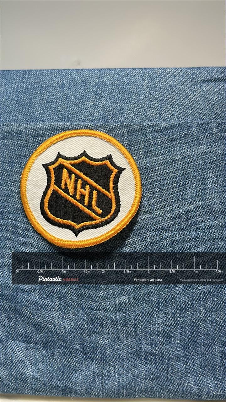 NHL League Collectable Patch: Sew-On Black & Gold Shield - Vintage Sports Accessory with ruler overlay for size reference