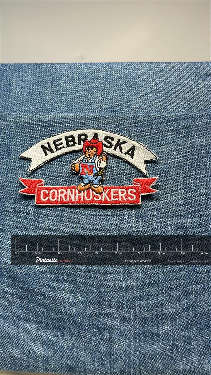 Nebraska Cornhuskers Collectable Patch: Iron-On Colorful Mascot - Vintage College Accessory with ruler overlay for size refer