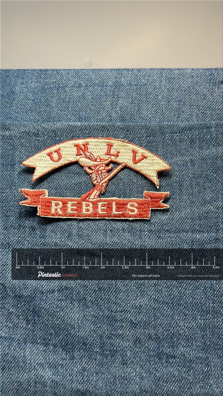 UNLV Rebels Collectable Patch: Iron-On Red/Beige - Vintage College Accessory with ruler overlay for size reference