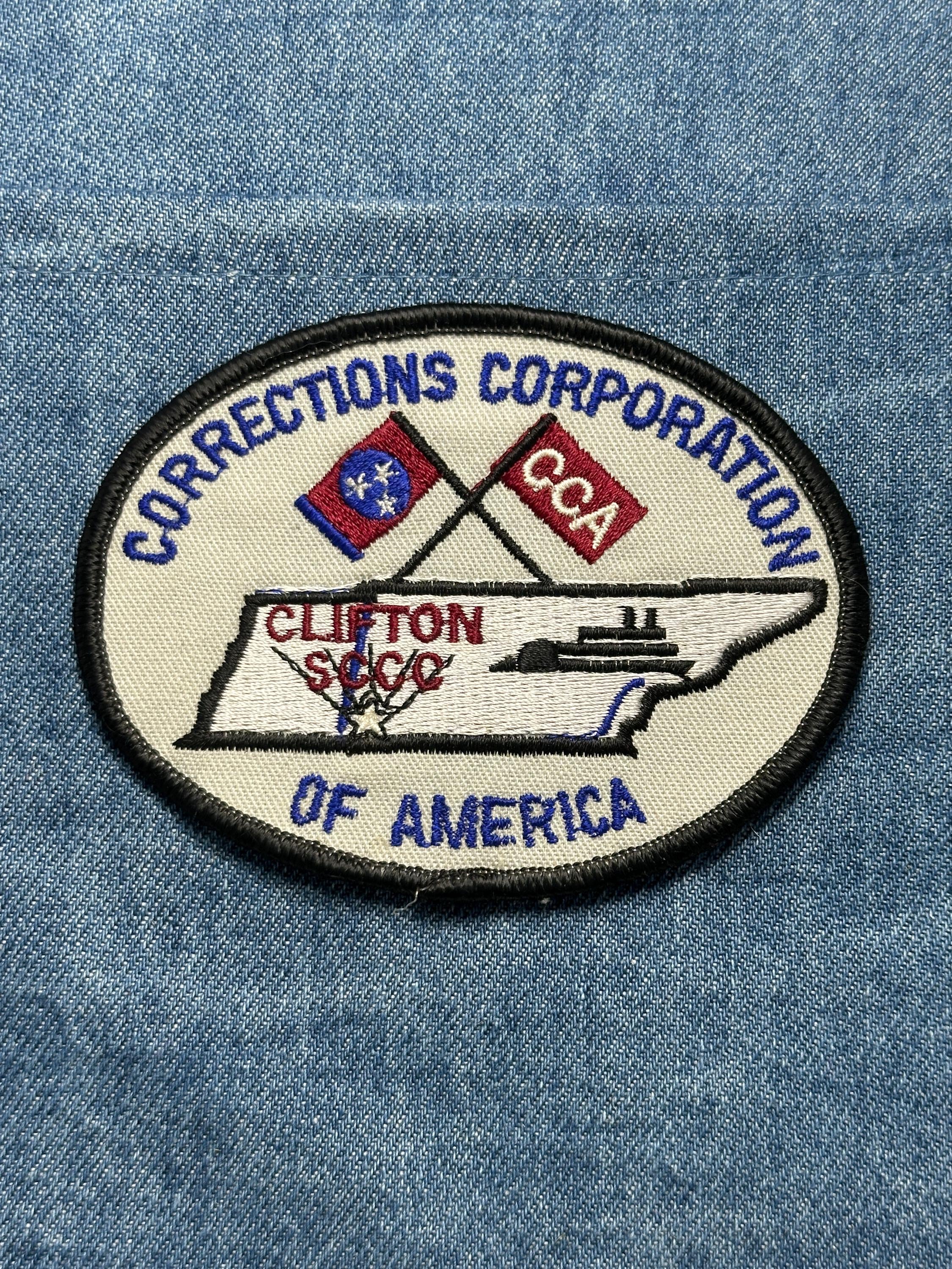 Corrections Corporation Collectable Patch: Iron-On Oval Red/Blue - Gov/Prison Accessory