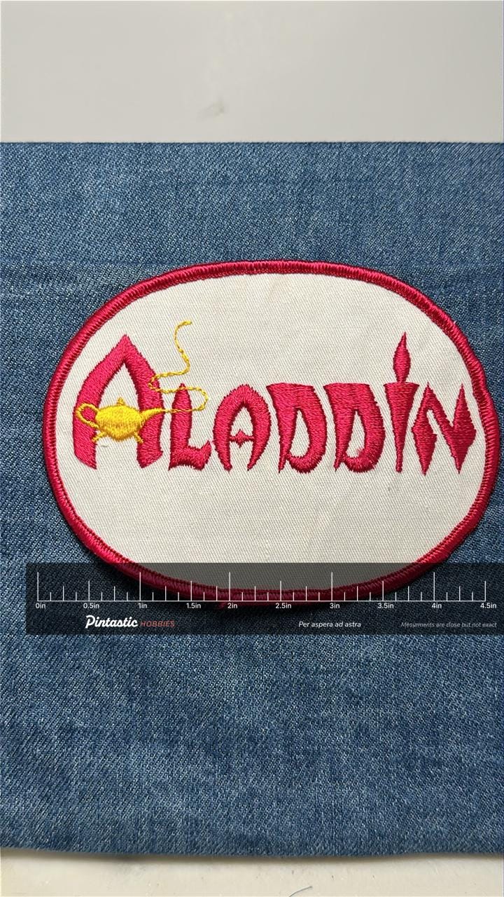 Aladdin Casino Collectable Patch: Sew-On Red & White Oval - Vintage Casino Accessory with ruler overlay for size reference