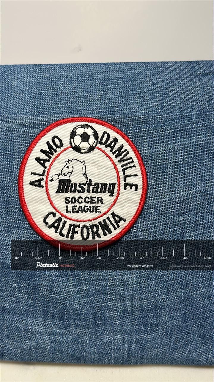 Mustang Soccer League Patch: Iron-On Red Border - Youth Sports Accessory with ruler overlay for size reference