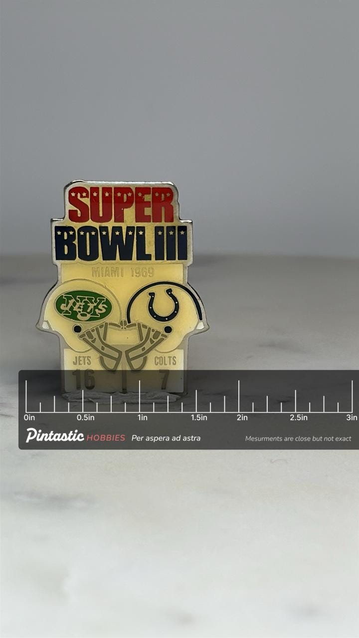 Super Bowl III Commemorative Pin: Enamel Helmet Design - 1969 Sports Accessory with ruler overlay for size reference