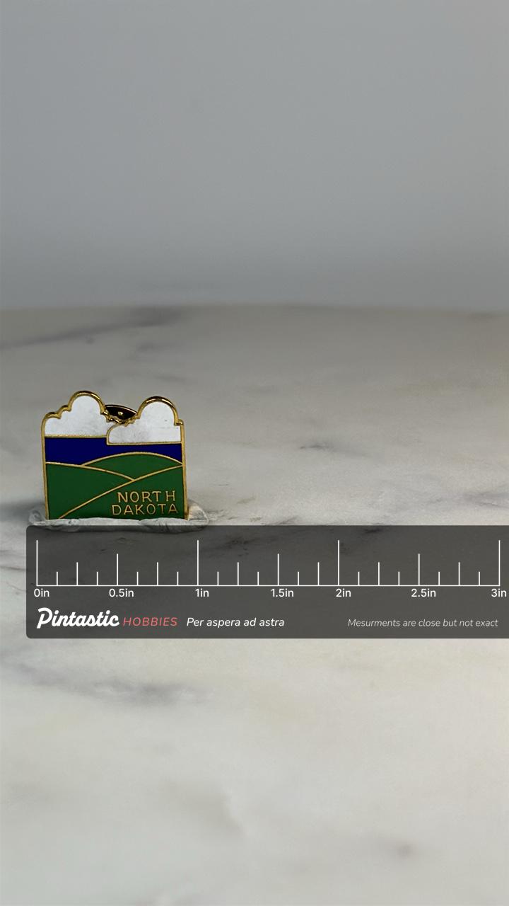 North Dakota State Pin: Green Blue Enamel - Travel Souvenir Accessory with ruler overlay for size reference