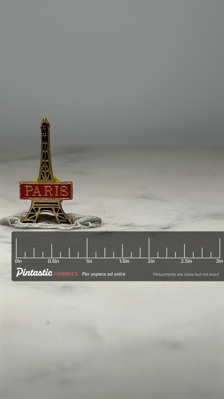 Eiffel Tower Souvenir Pin: Gold & Red Enamel - Paris Travel Accessory with ruler overlay for size reference