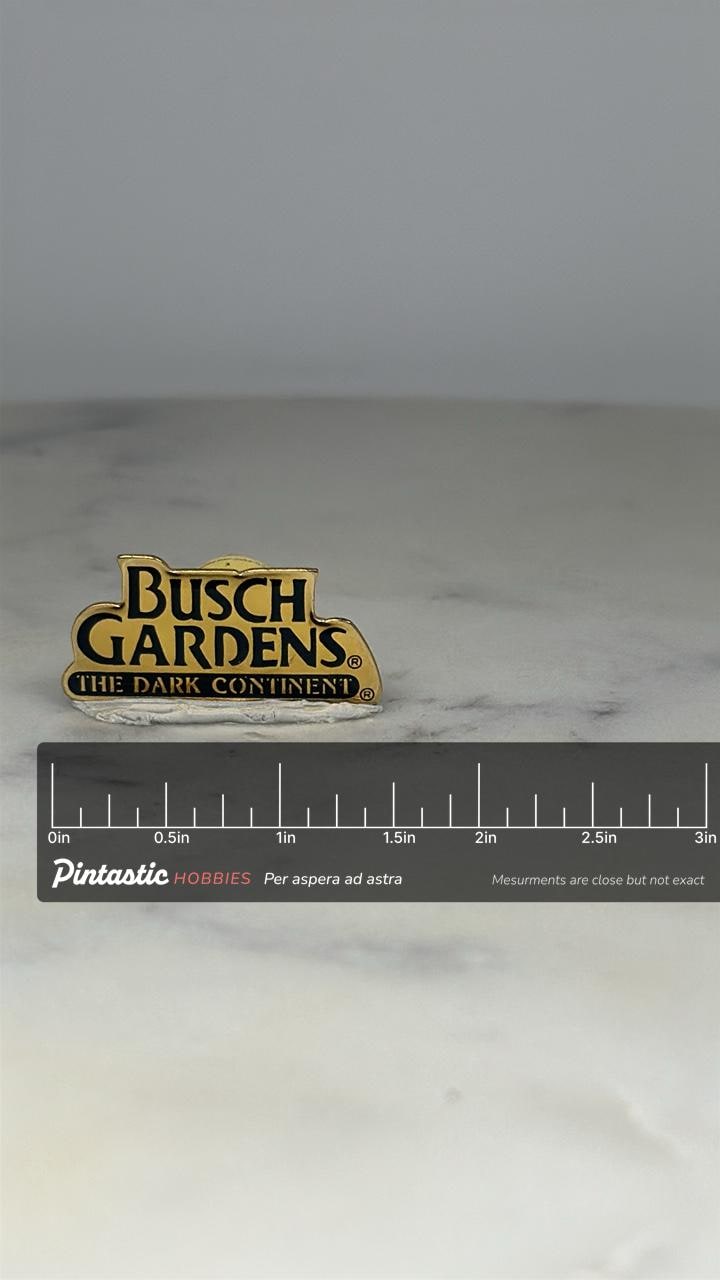 Busch Gardens The Dark Continent Pin: Gold Black Enamel - Vintage Theme Park Accessory with ruler overlay for size reference