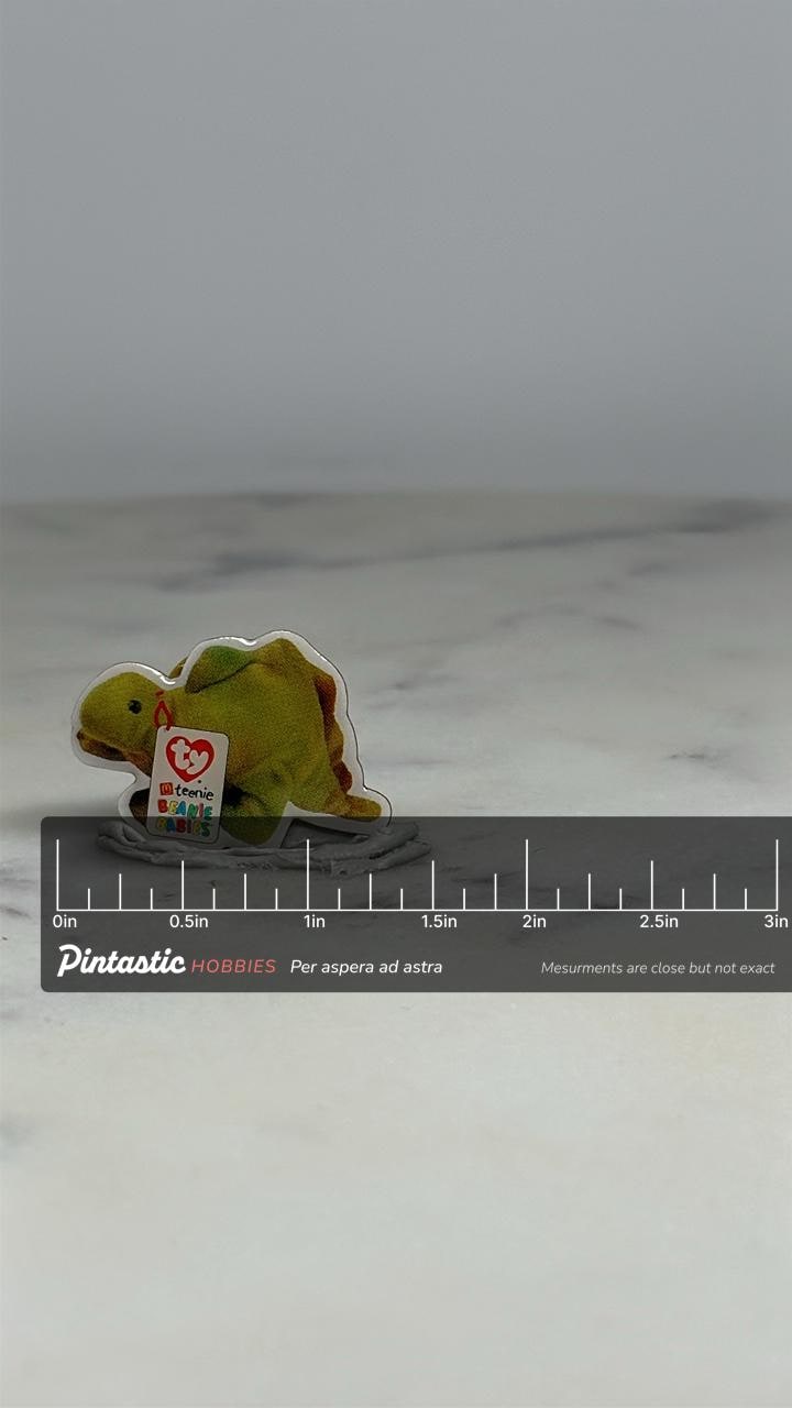 Beanie Babies Dinosaur Pin: Green Sticker Style - 90s Toy Accessory with ruler overlay for size reference