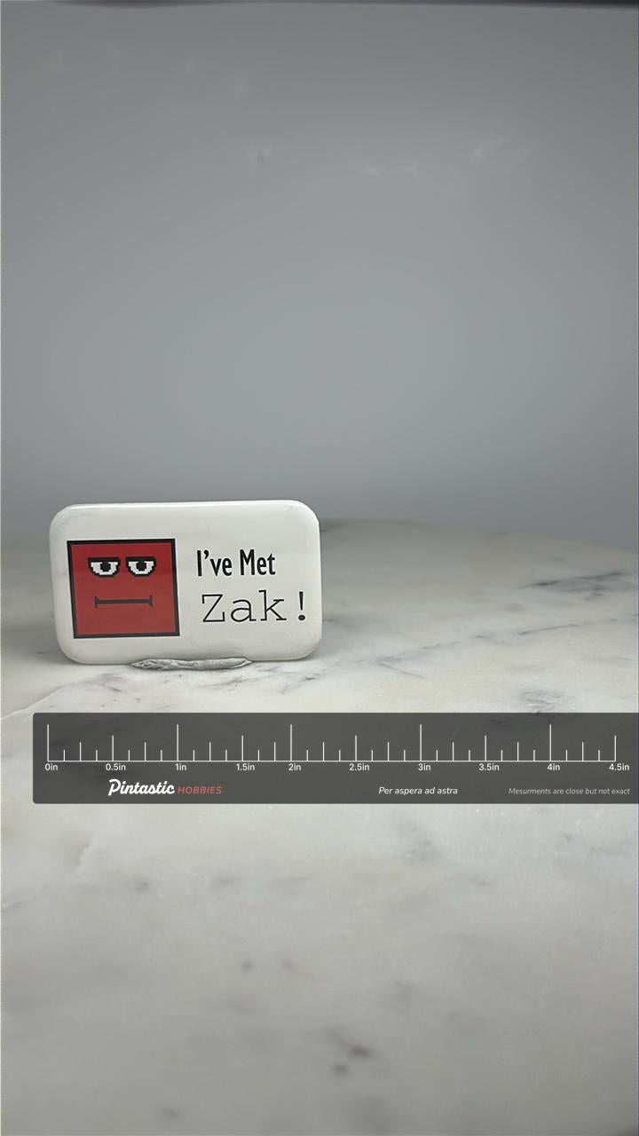 Zak Character Pin: Red Pixel Art Face - Retro Collectible Accessory with ruler overlay for size reference